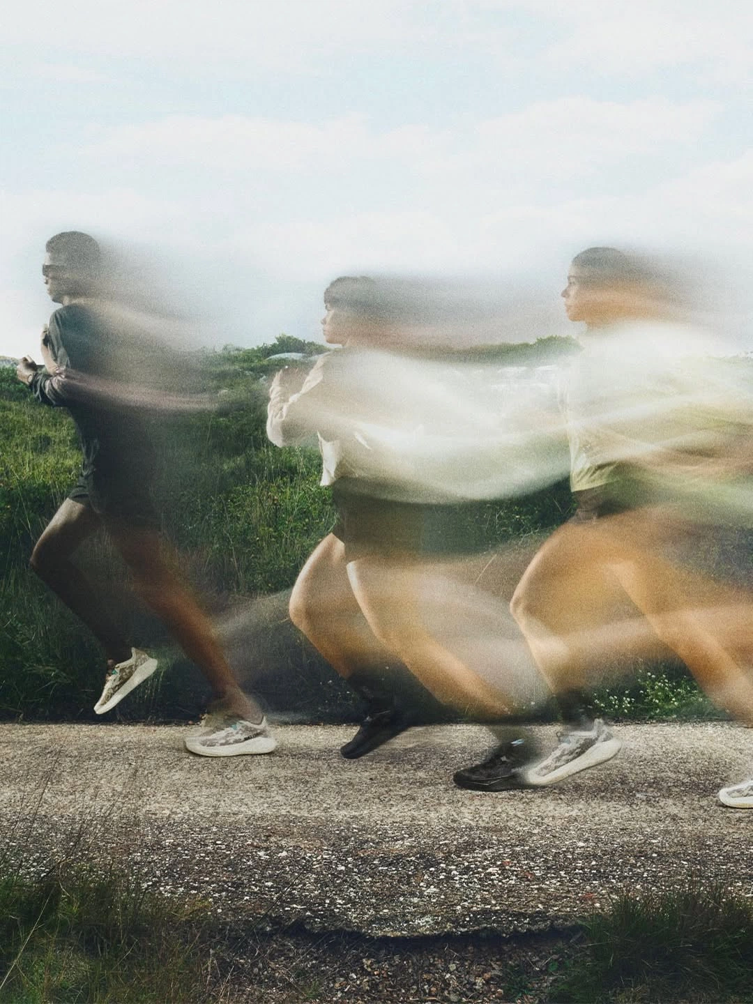 Runners moving along an outdoor path with motion blur.